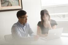 2 people working on laptop